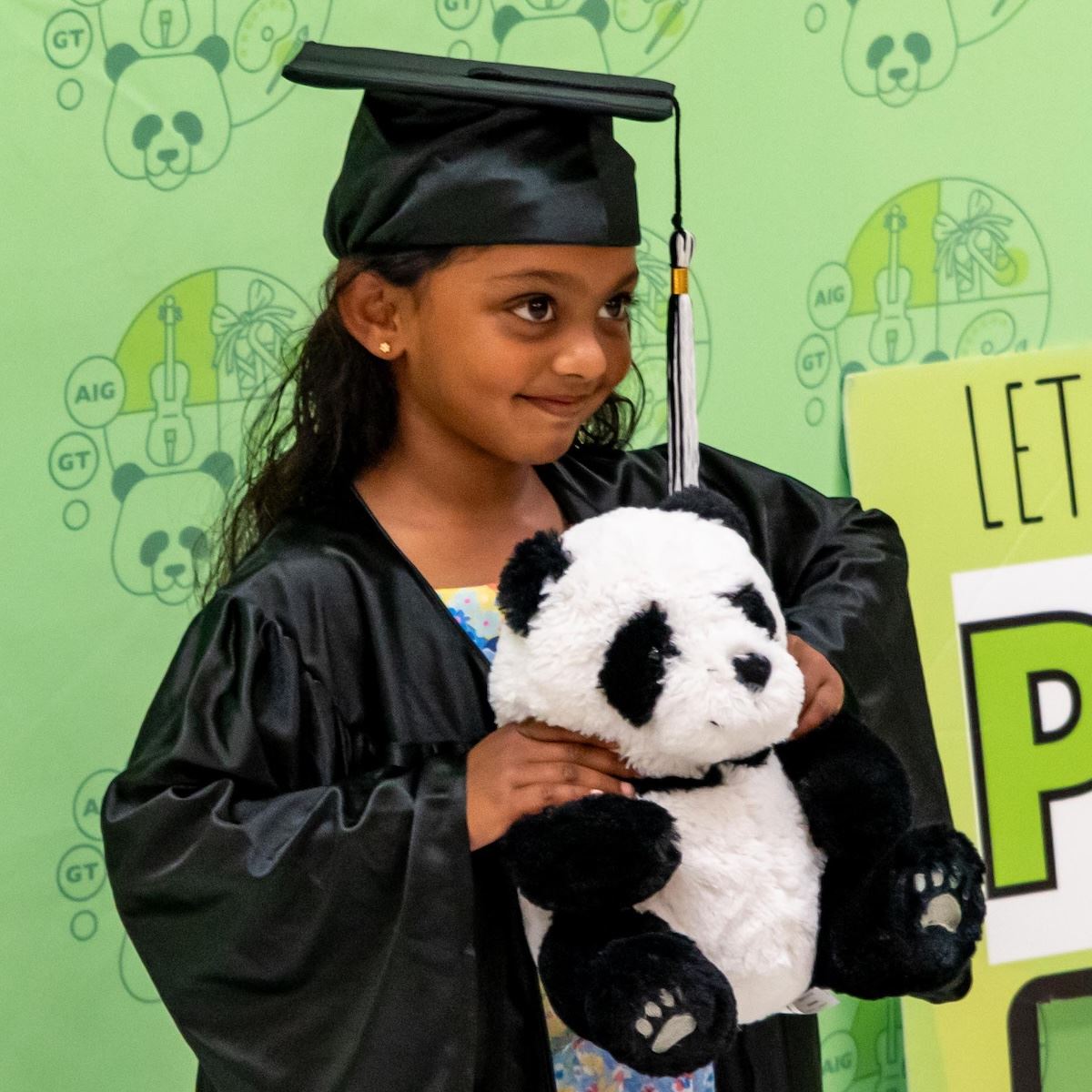  A Kindergarten student wearing a graduation cap and gown
